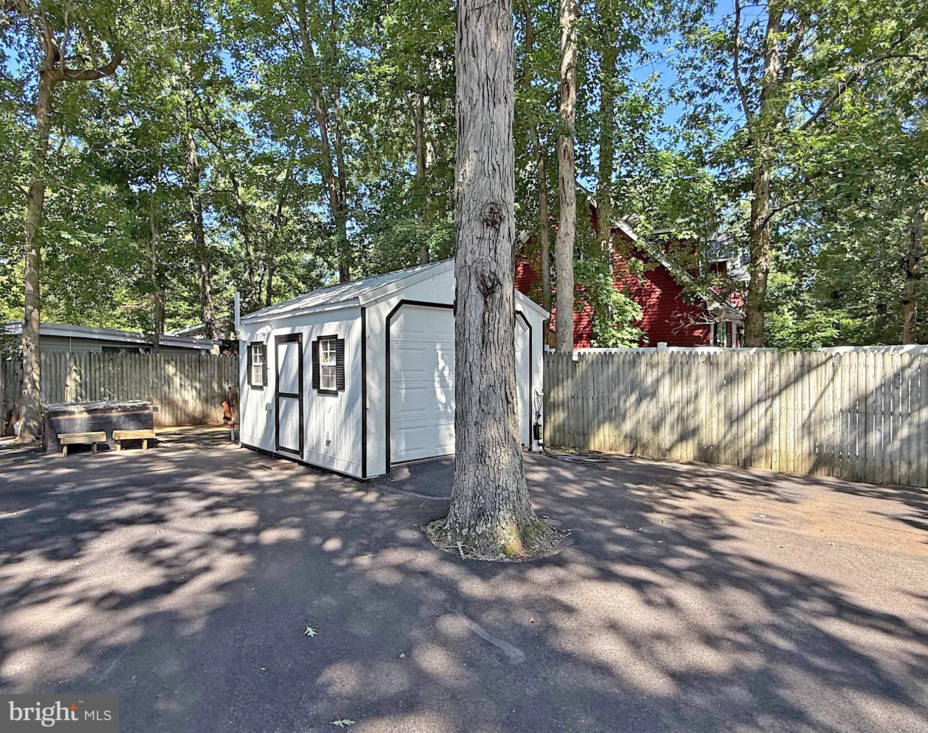 33280 Sassafras Court Ocean View, DE 19970 - Photo 37 of 45 a view of a house with large tree and wooden fence