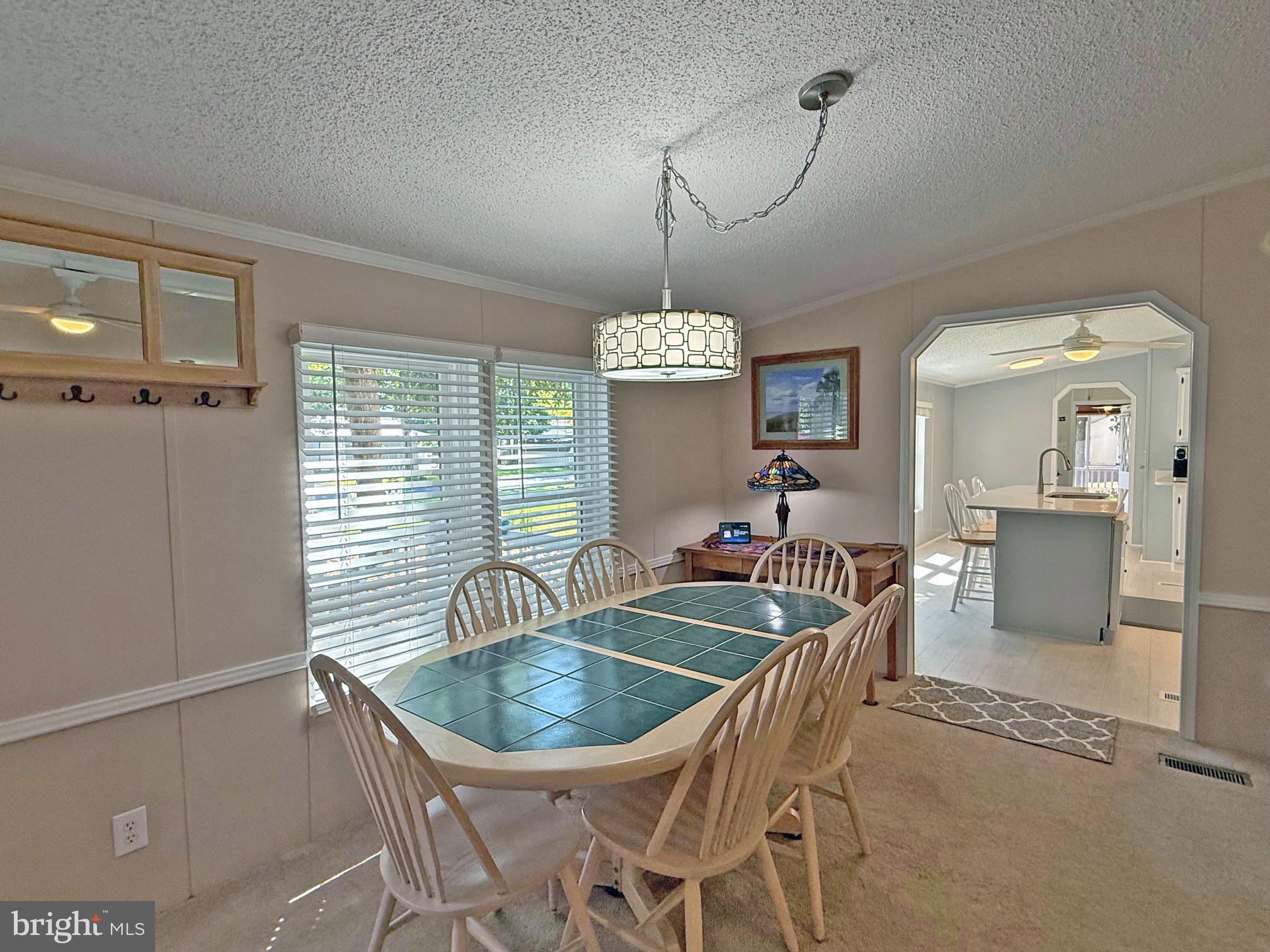 33280 Sassafras Court Ocean View, DE 19970 - Photo 8 of 45 a dining room with furniture a chandelier and window