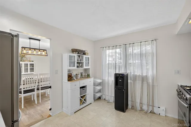 a dining room with furniture a chandelier and wooden floor