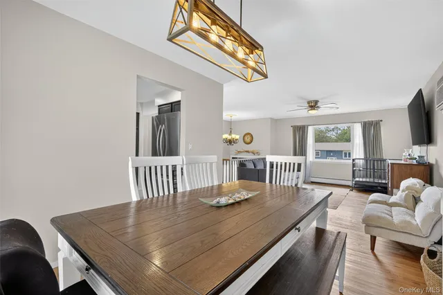 a living room with furniture wooden floor and dining table