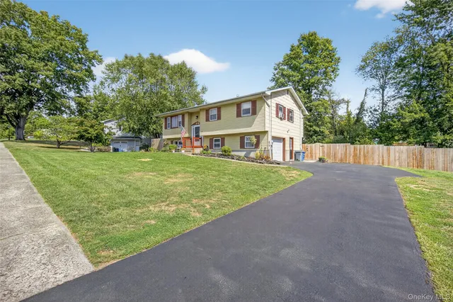 a view of a house with a yard and sitting area