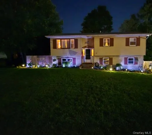 a front view of house with a garden