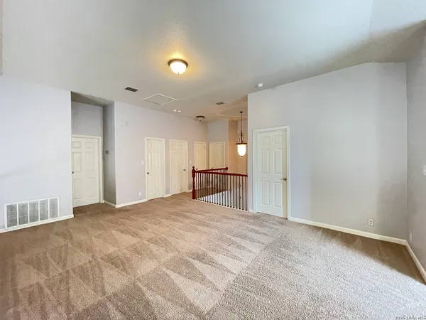 a view of an empty room with a cabinet