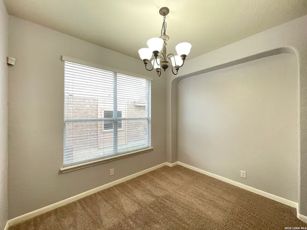 a view of a room with a chandelier and a window