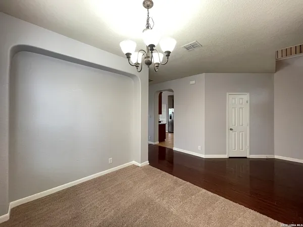 a view of a chandelier fan and entryway