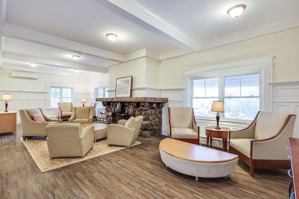 165 Woods Hole Road Falmouth, MA 02540 - Photo 12 of 35 a living room with furniture a table and a large window