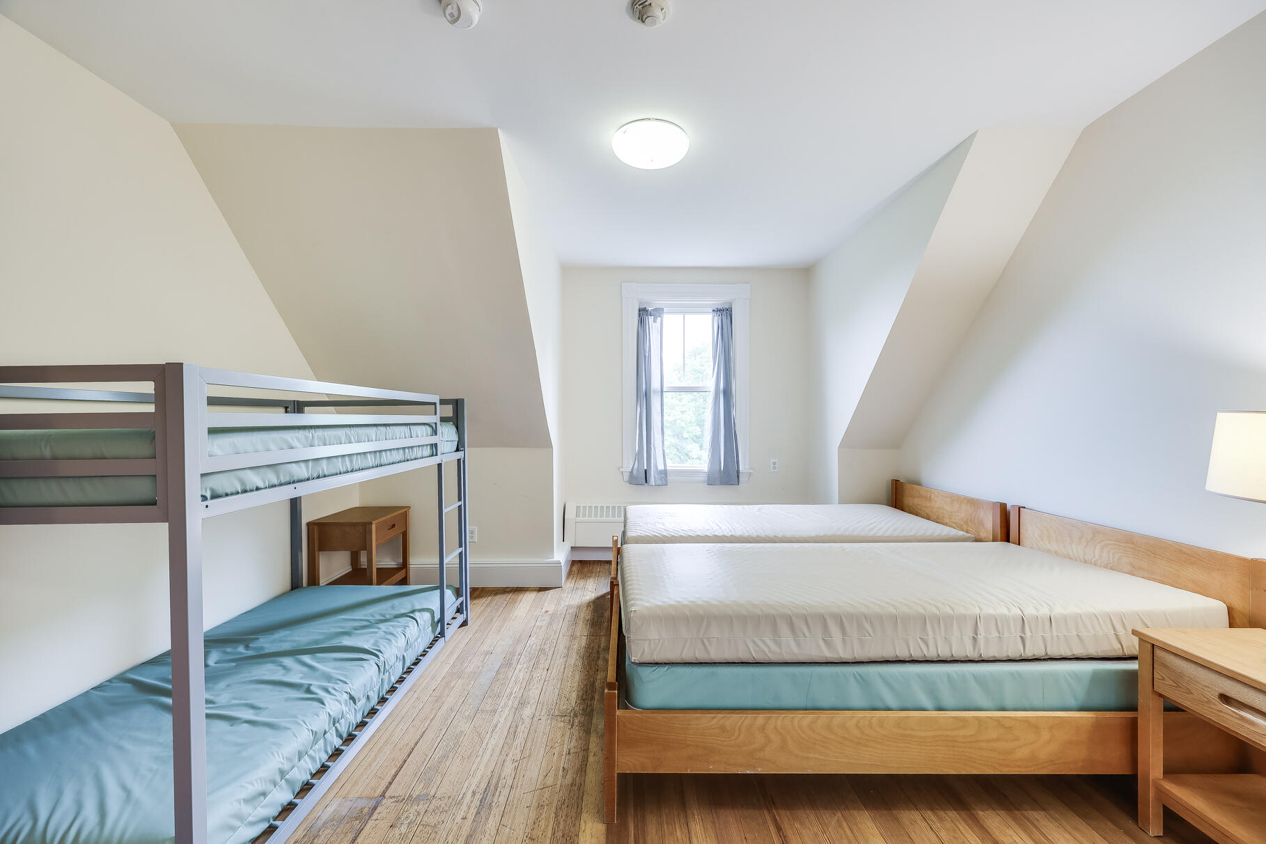 165 Woods Hole Road Falmouth, MA 02540 - Photo 20 of 35 a bedroom with a bed and a fireplace