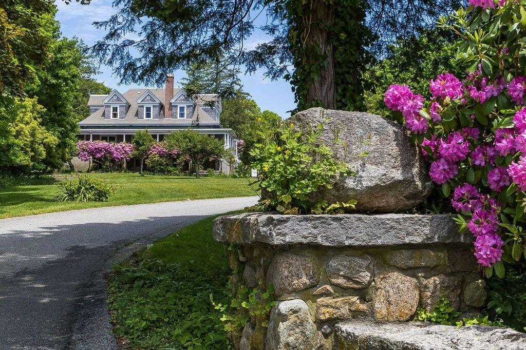 165 Woods Hole Road Falmouth, MA 02540 - Photo 6 of 35 a sign that is sitting on a brick wall