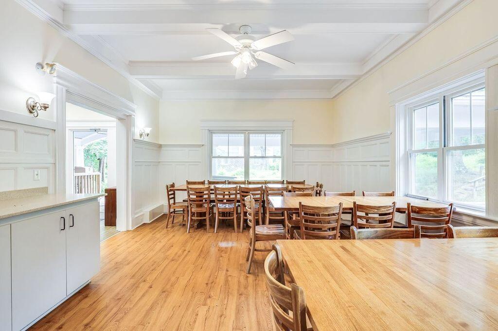 165 Woods Hole Road Falmouth, MA 02540 - Photo 7 of 35 a living room with furniture a wooden floor and a chandelier