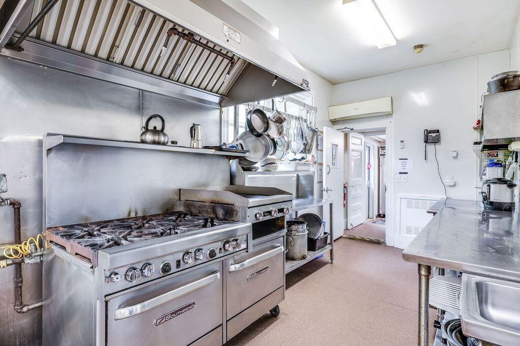 165 Woods Hole Road Falmouth, MA 02540 - Photo 9 of 35 a kitchen with a stove and cabinets