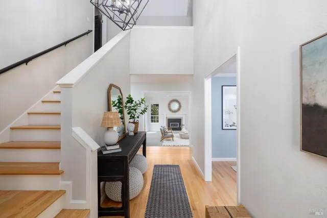 a view of entryway and hall with wooden floor