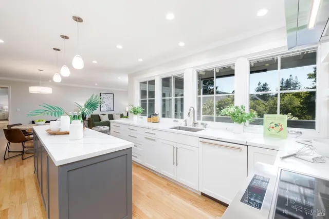 a kitchen with a sink and living room