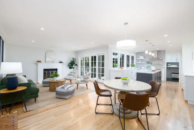 a dining room with furniture a fireplace and wooden floor