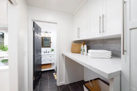 an aerial view of a house with a yard and greenery