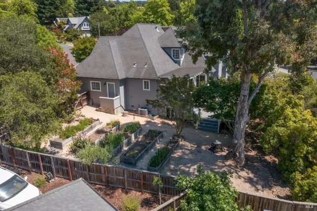 a view of house with yard and sitting area
