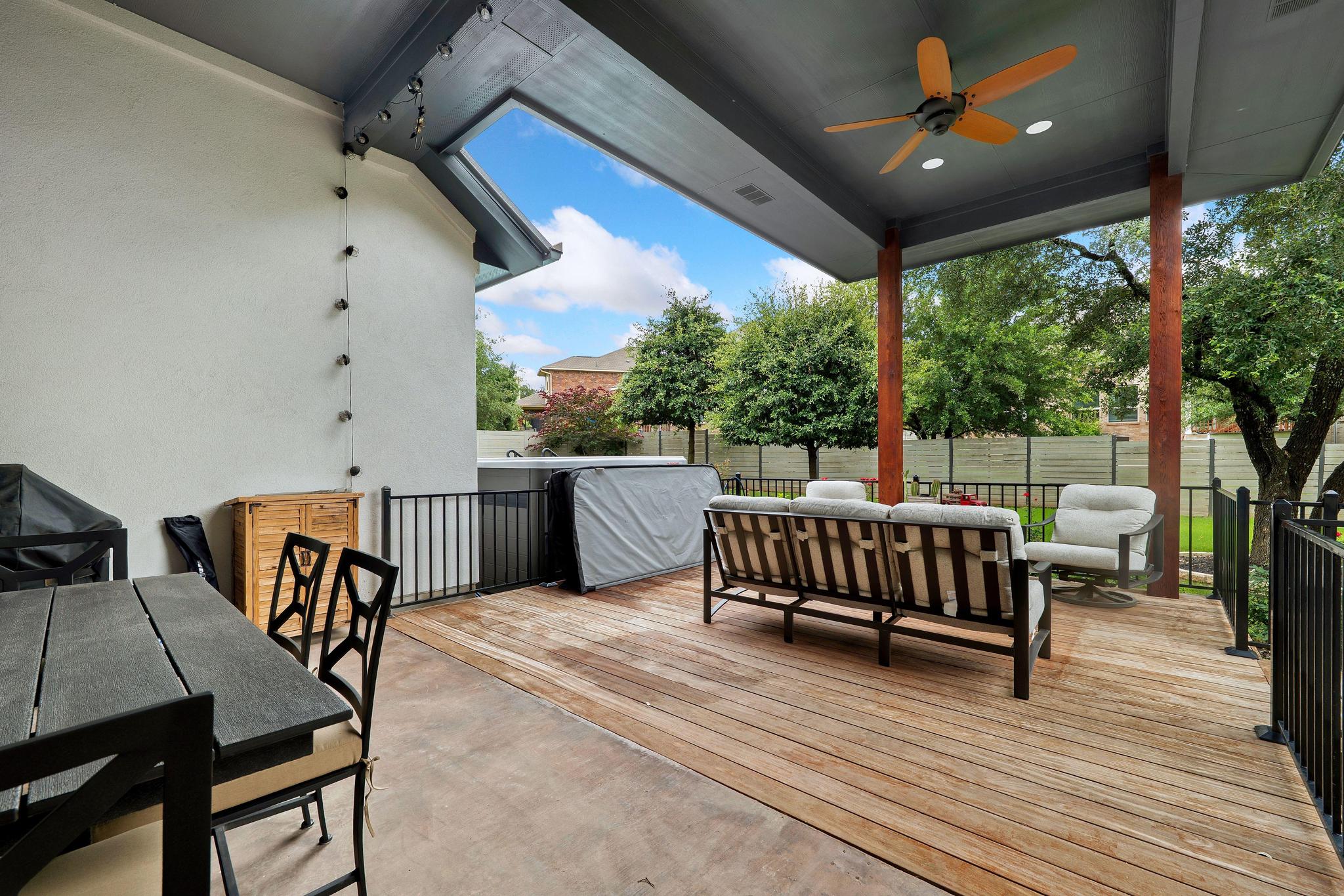 1009 Legacy Crossing Georgetown, TX 78628 - Photo 30 of 40 An inviting outdoor living space features a wooden deck and a hot tub for ultimate relaxation.