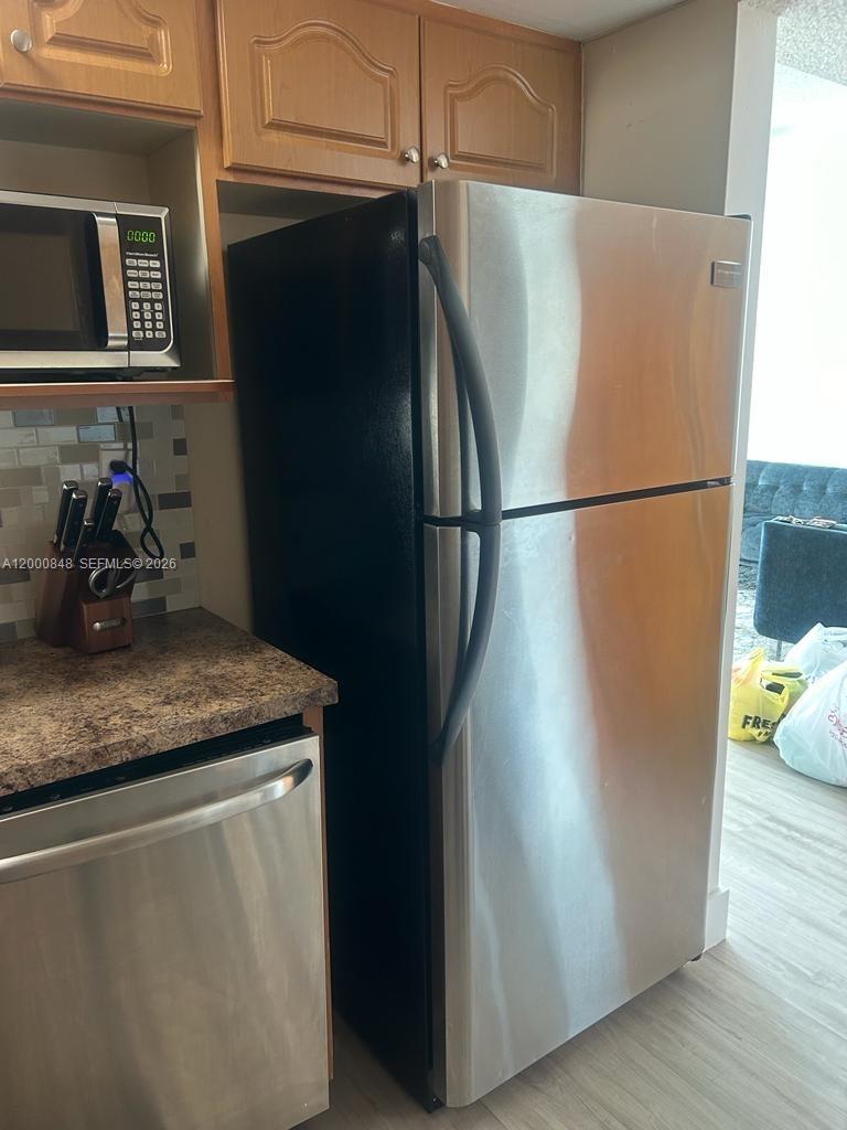 11790 Southwest 18th Street, Unit 4053 Miami, FL 33175 - Photo 8 of 17 a white refrigerator freezer sitting in a kitchen