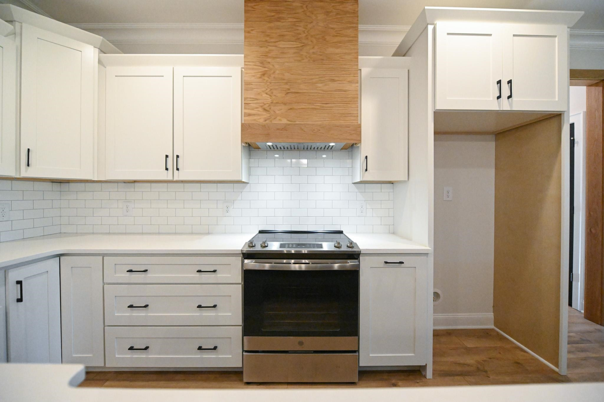 996 Barnes Road Middlesex, NC 27557 - Photo 12 of 39 a kitchen with granite countertop white cabinets and stainless steel appliances