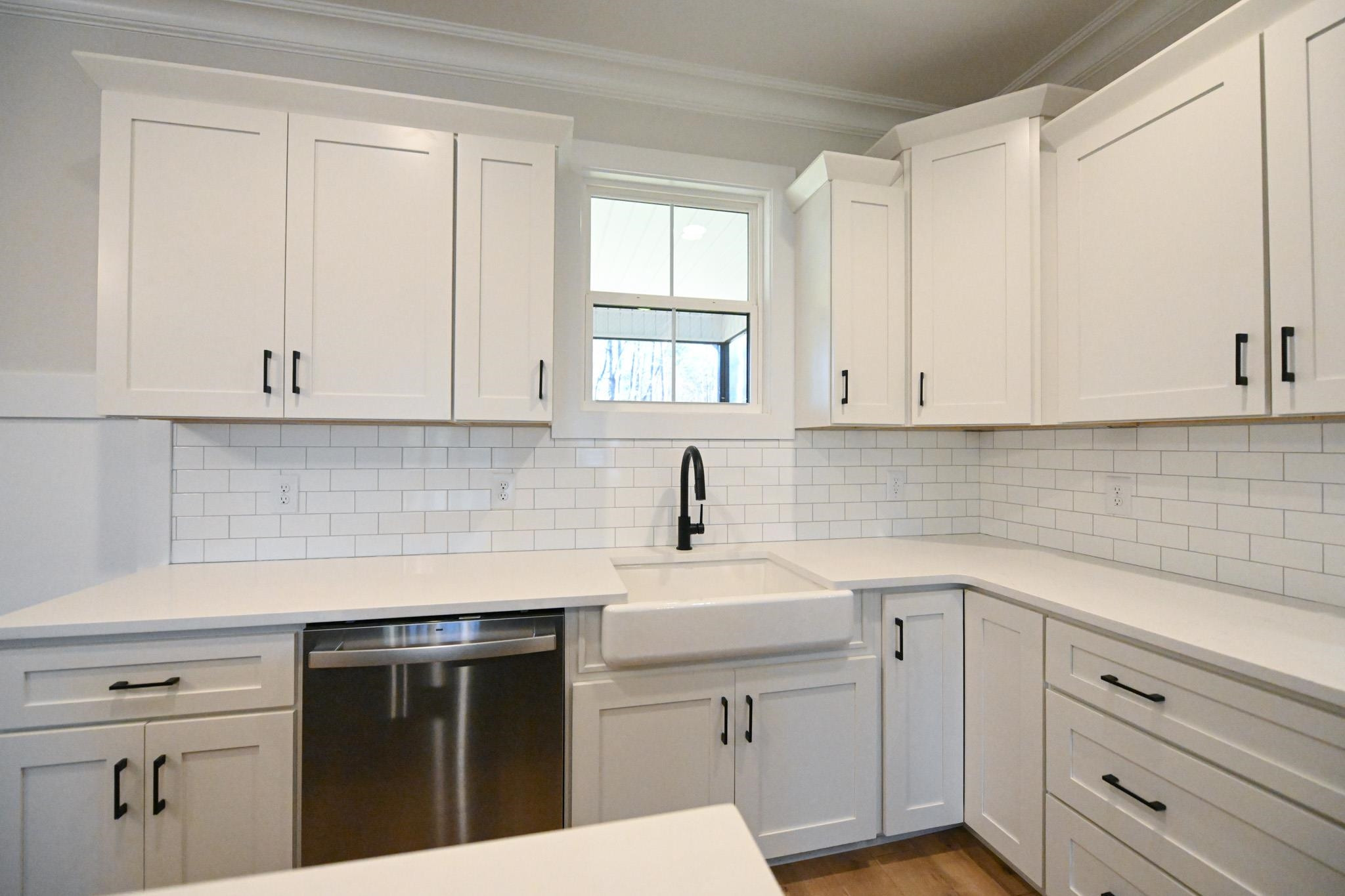 996 Barnes Road Middlesex, NC 27557 - Photo 13 of 39 a kitchen with white cabinets appliances a sink and a window