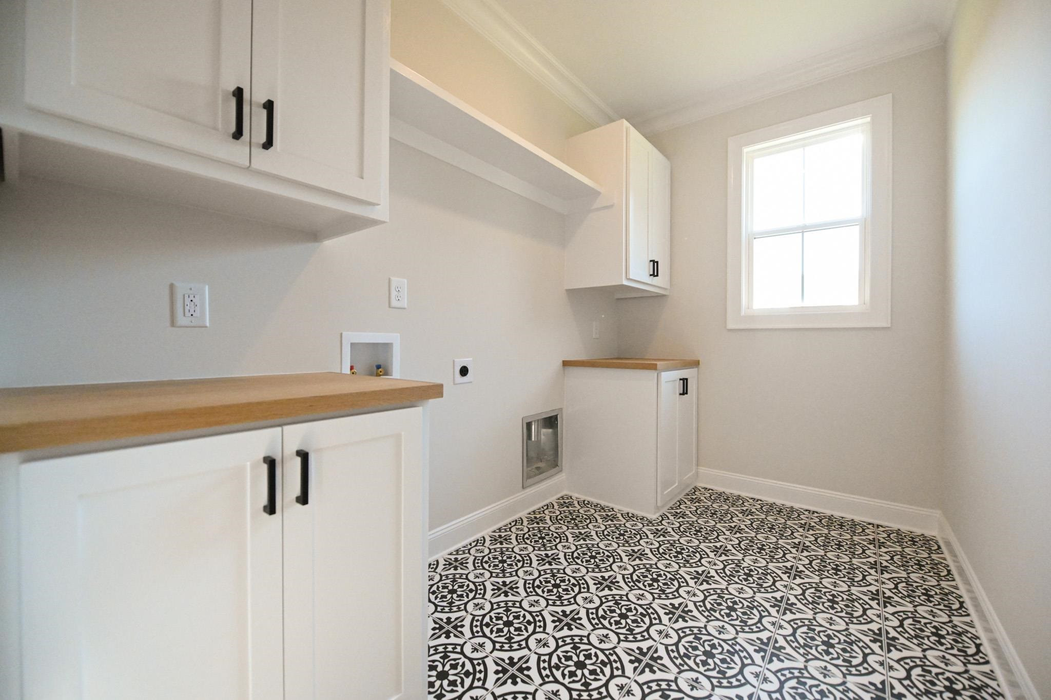 996 Barnes Road Middlesex, NC 27557 - Photo 18 of 39 a kitchen with a refrigerator and white cabinets
