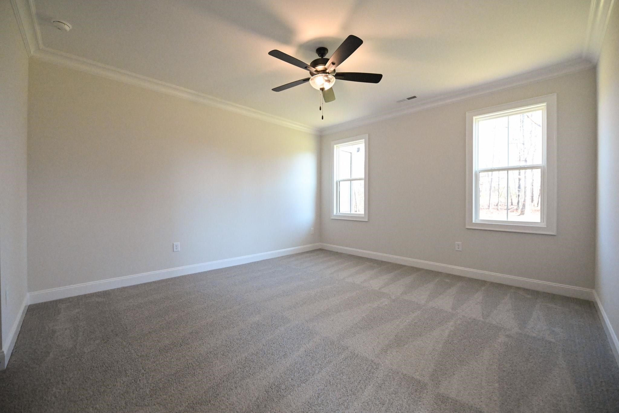 996 Barnes Road Middlesex, NC 27557 - Photo 22 of 39 an empty room with a window and a ceiling fan