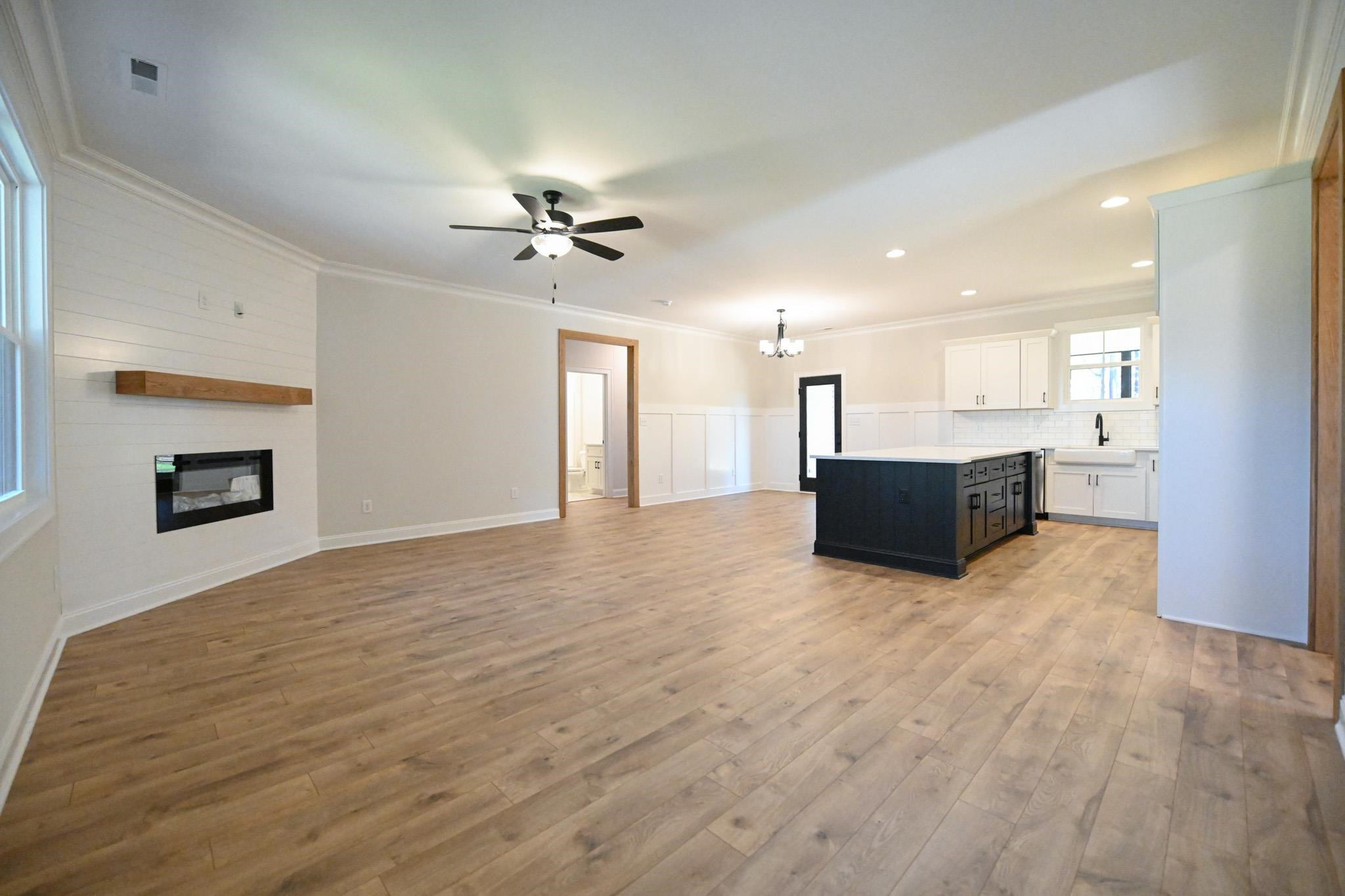 996 Barnes Road Middlesex, NC 27557 - Photo 4 of 39 a view of kitchen and empty room with a fireplace