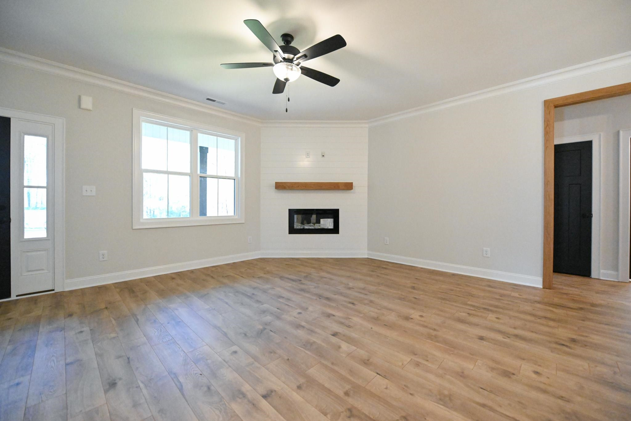 996 Barnes Road Middlesex, NC 27557 - Photo 5 of 39 a view of an empty room with a window and wooden floor