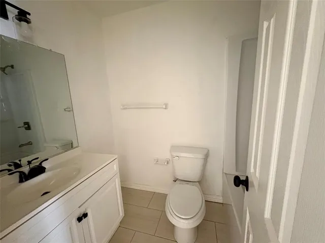 a white toilet sitting next to a bathroom sink