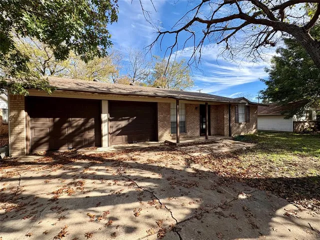 a front view of a house with a yard covered with snow in front of house