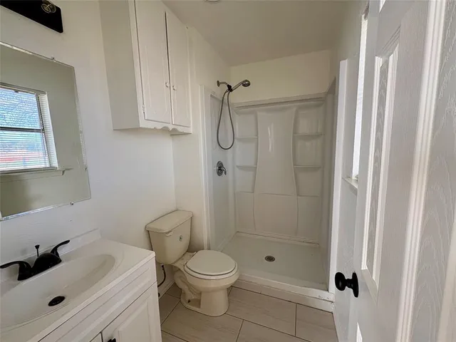 a bathroom with a shower toilet and sink