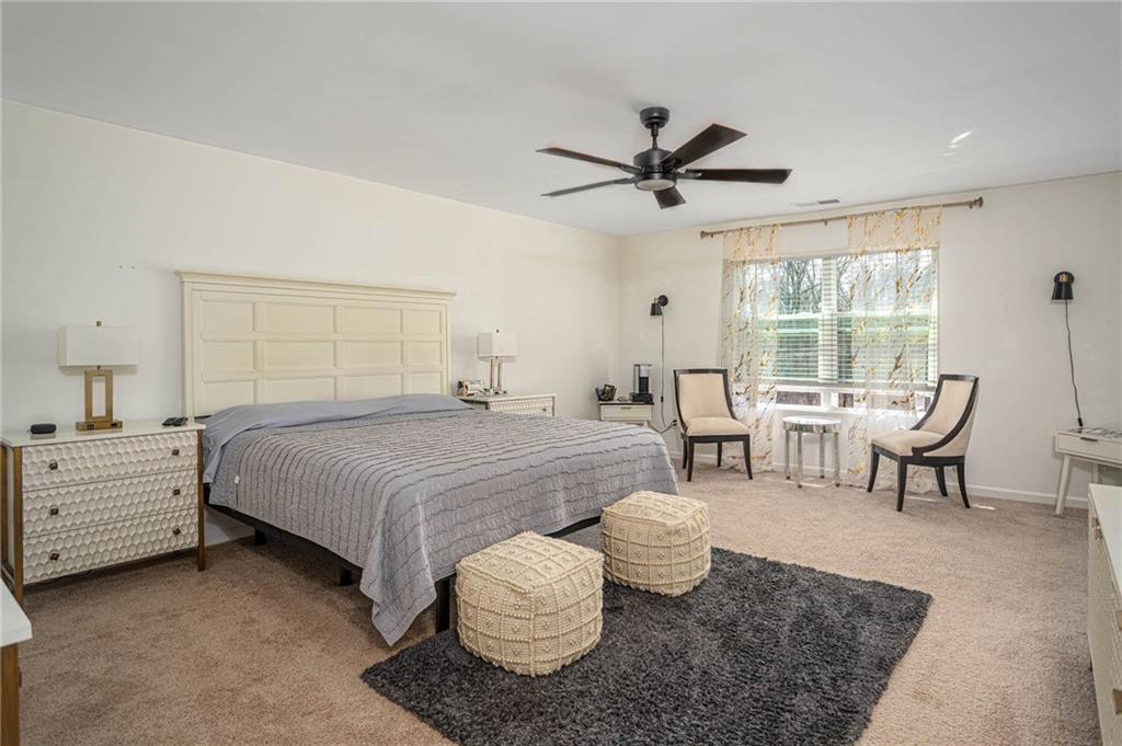 5760 Flint Lane Cumming, GA 30028 - Photo 17 of 39 a bedroom with a bed and a chandelier