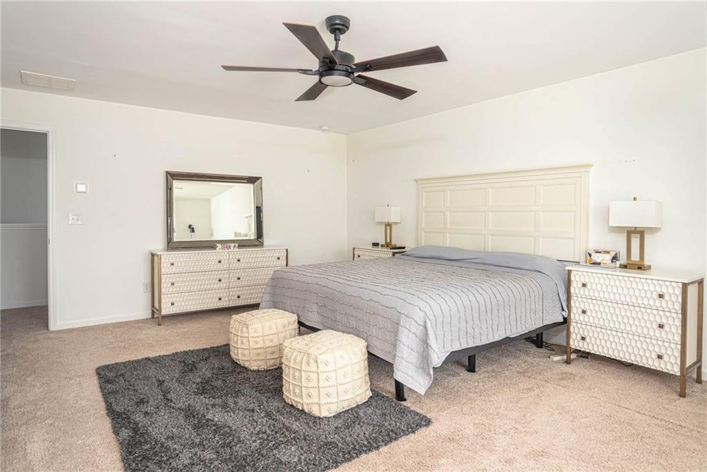 5760 Flint Lane Cumming, GA 30028 - Photo 19 of 39 a spacious bedroom with a bed and a dresser