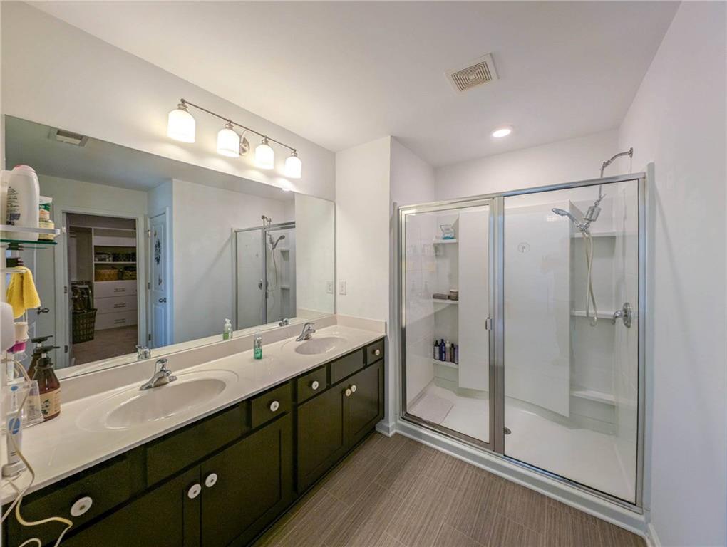 5760 Flint Lane Cumming, GA 30028 - Photo 21 of 39 a bathroom with a double vanity sink mirror and shower