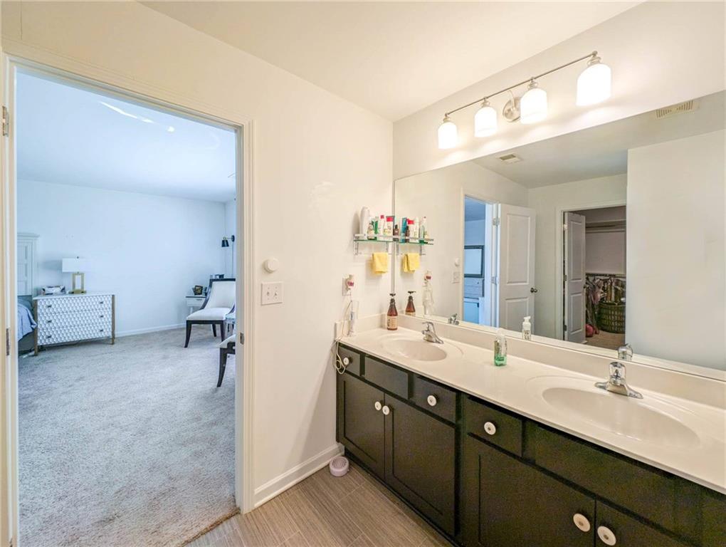 5760 Flint Lane Cumming, GA 30028 - Photo 22 of 39 a bathroom with a double vanity sink and mirror