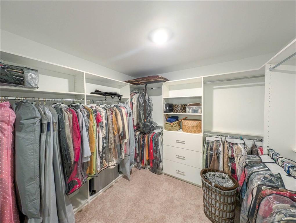 5760 Flint Lane Cumming, GA 30028 - Photo 23 of 39 a view of walk in closet with clothes and shoes