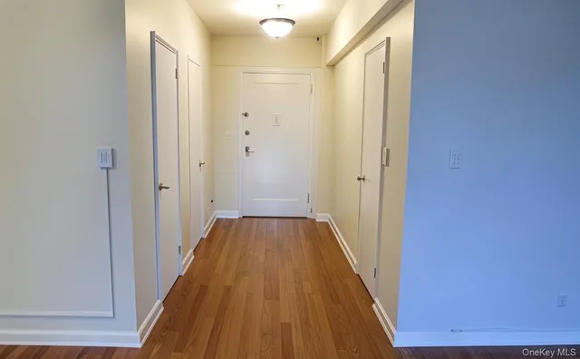 a view of a hallway with wooden floor