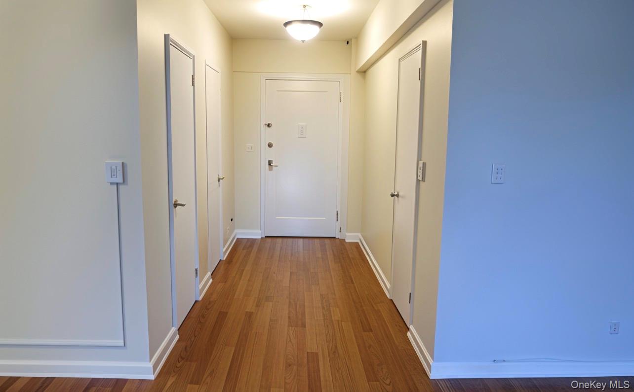 a view of a hallway with wooden floor