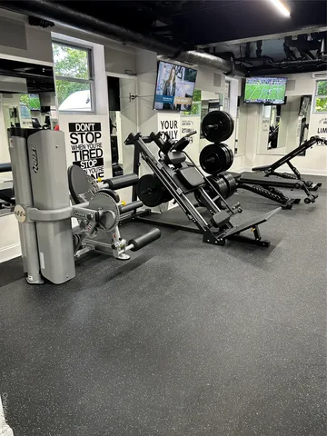a room with gym equipment and large window