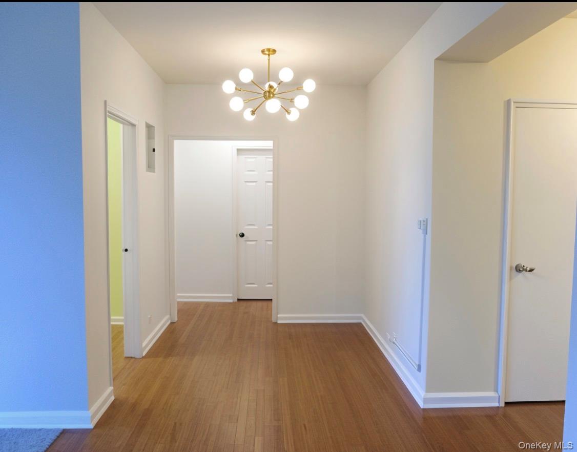 220 Pelham Road, Unit 6G New Rochelle, NY 10805 - Photo 2 of 24 a view of an empty room with wooden floor