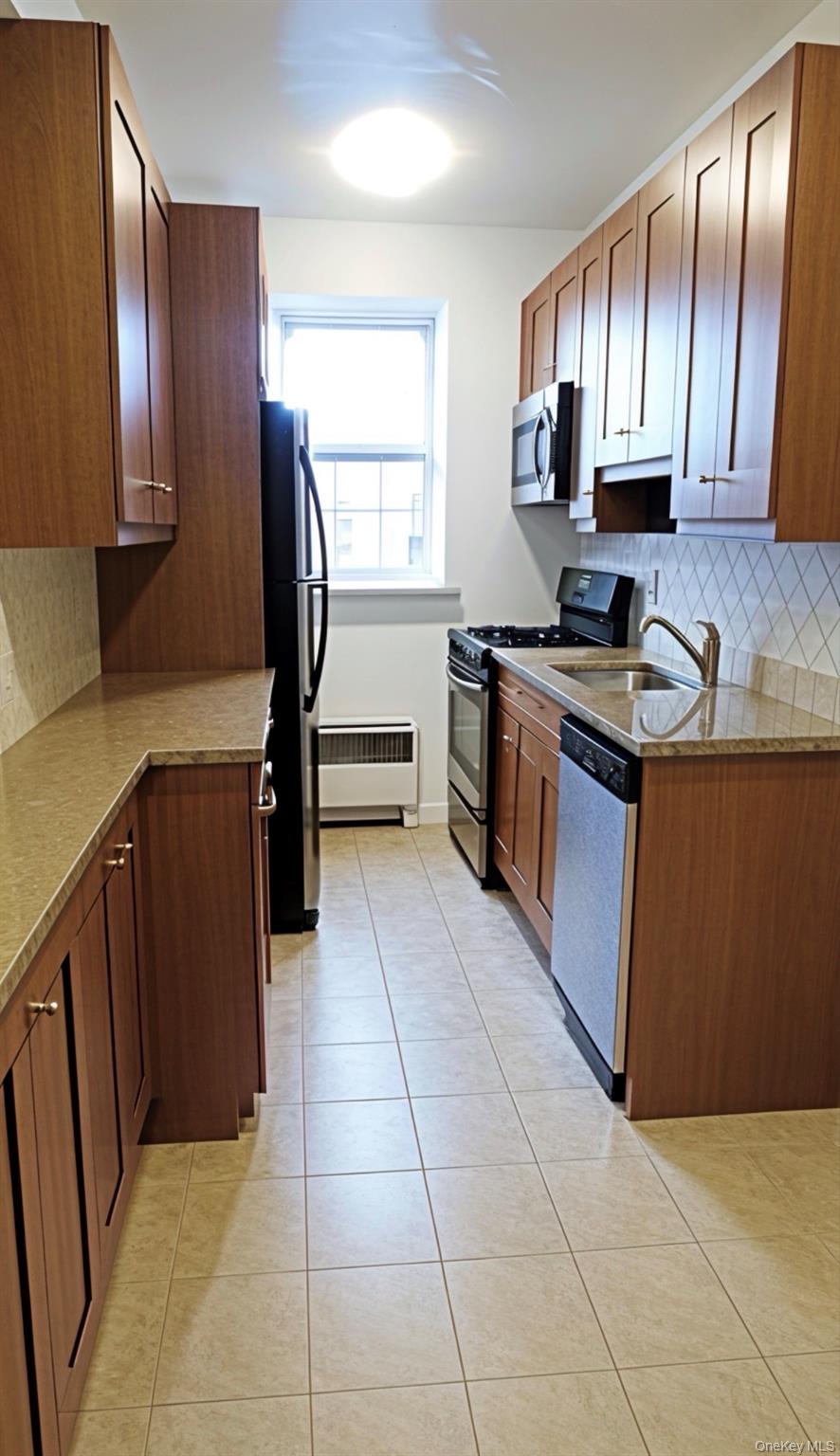 220 Pelham Road, Unit 6G New Rochelle, NY 10805 - Photo 6 of 24 a kitchen with stainless steel appliances granite countertop wooden cabinets a sink and a stove