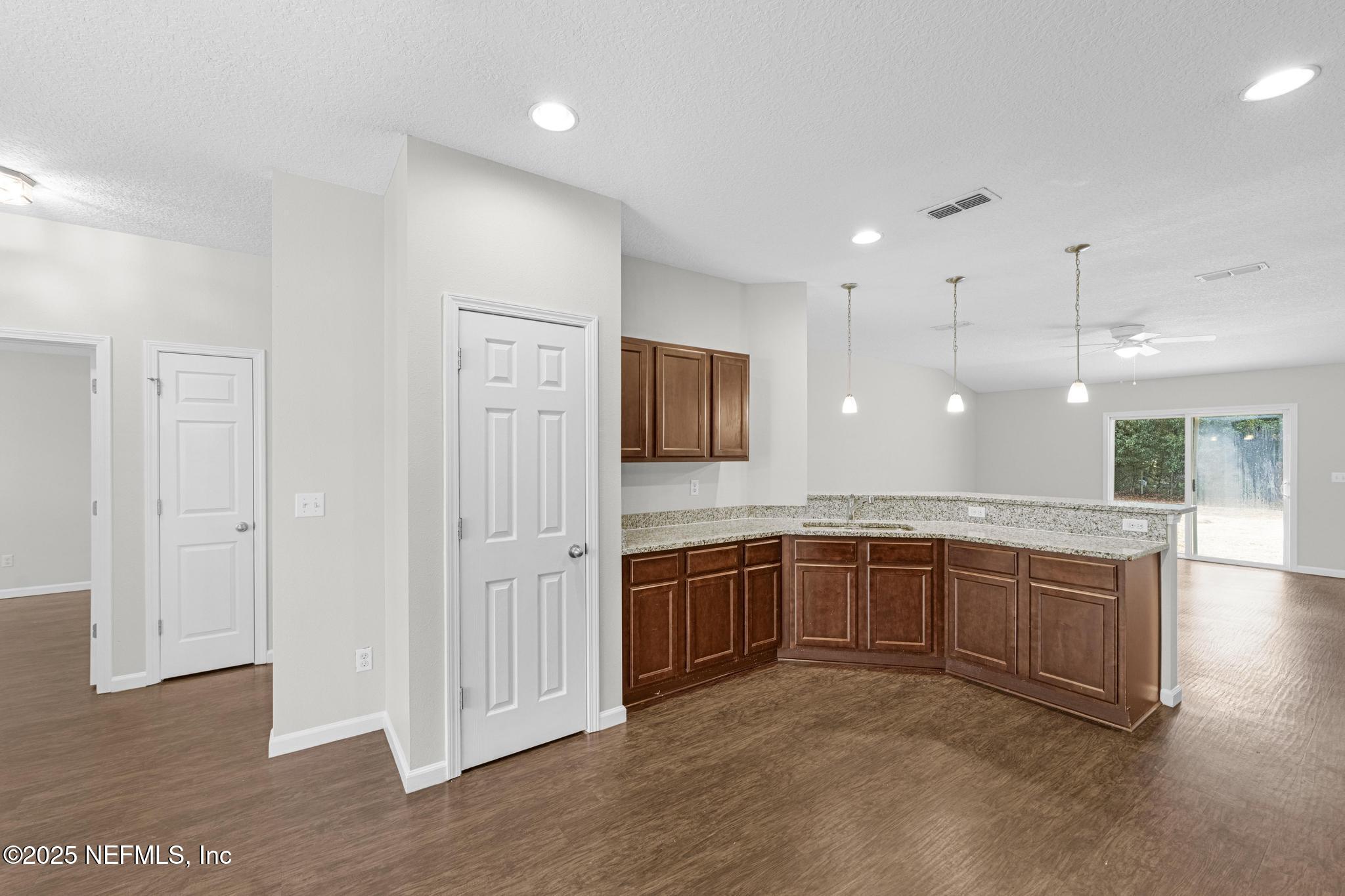 5120 Dugdale Road Jacksonville, FL 32210 - Photo 11 of 32 a large bathroom with a granite countertop sink and a large mirror
