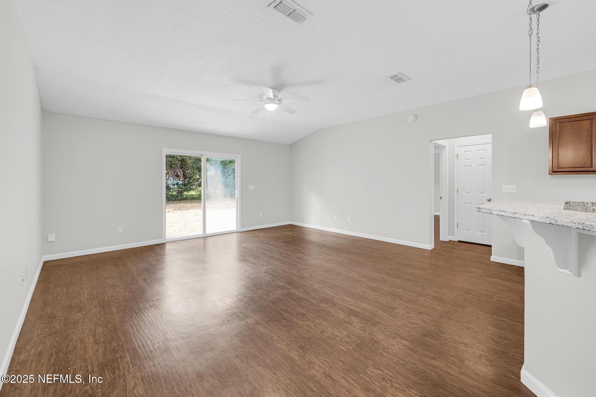 5120 Dugdale Road Jacksonville, FL 32210 - Photo 13 of 32 a view of empty room with wooden floor and fan