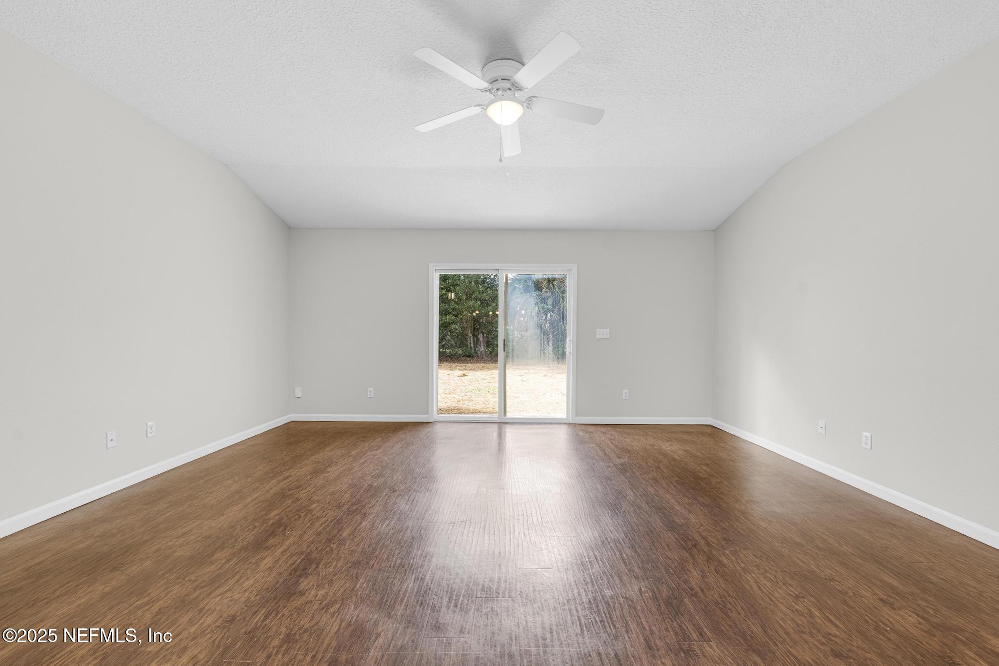 5120 Dugdale Road Jacksonville, FL 32210 - Photo 15 of 32 an empty room with wooden floor and windows