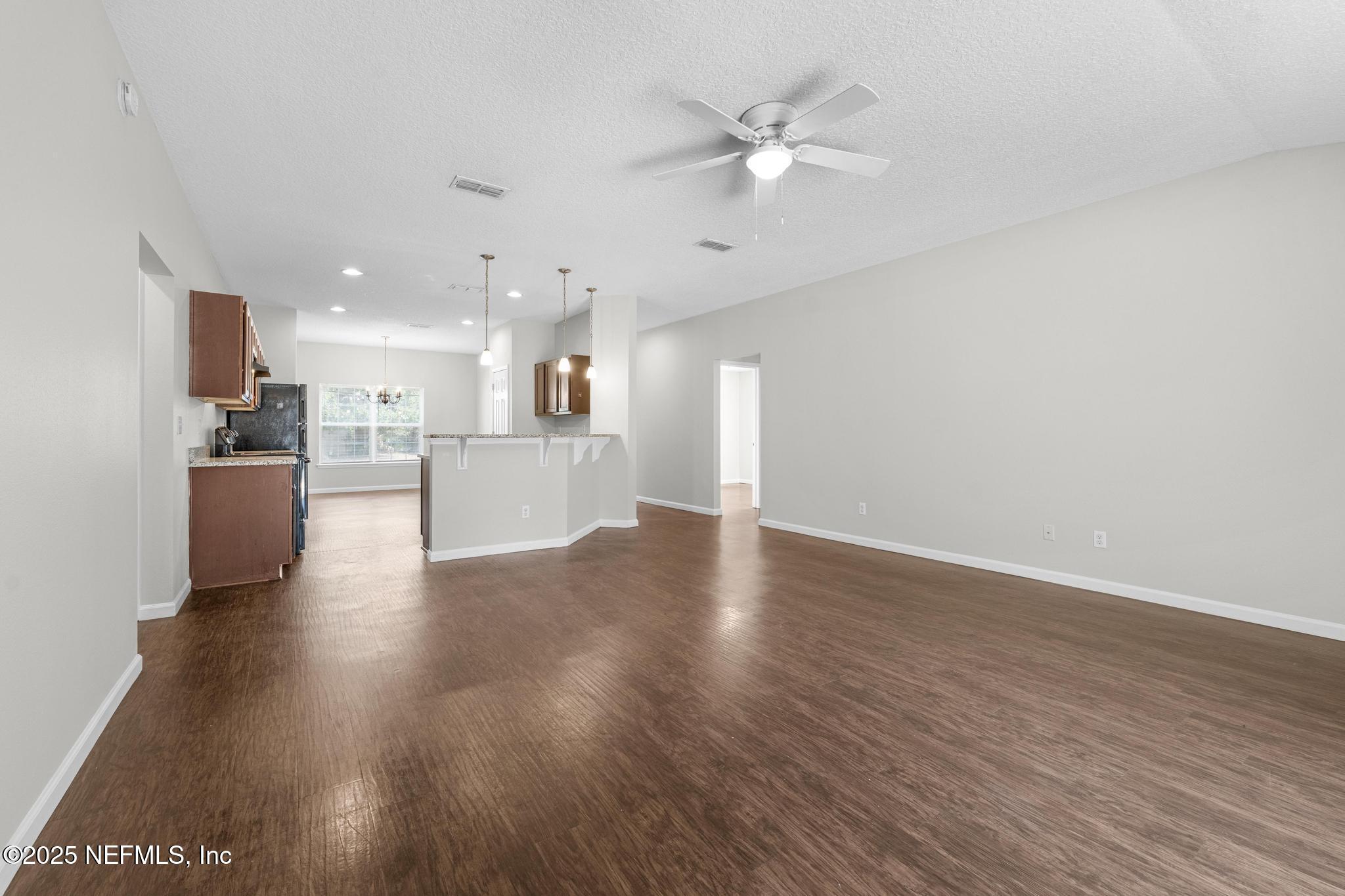 5120 Dugdale Road Jacksonville, FL 32210 - Photo 17 of 32 a view of a kitchen with a sink a refrigerator and a fireplace