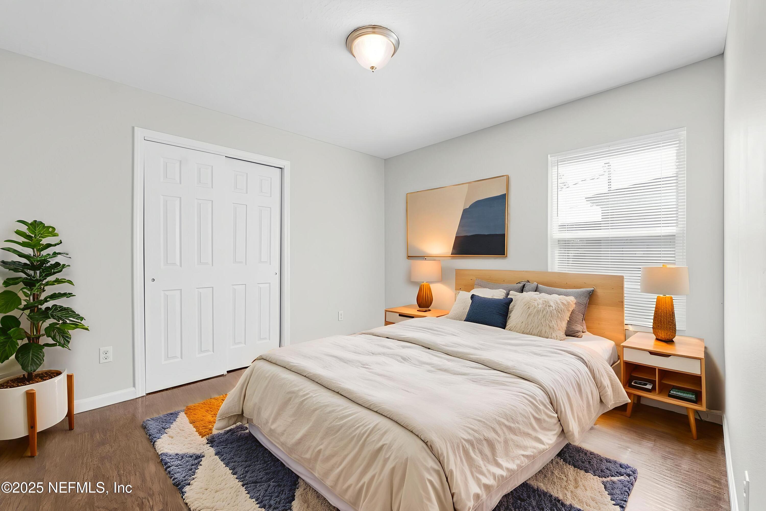 5120 Dugdale Road Jacksonville, FL 32210 - Photo 24 of 32 a bedroom with a bed and a potted plant