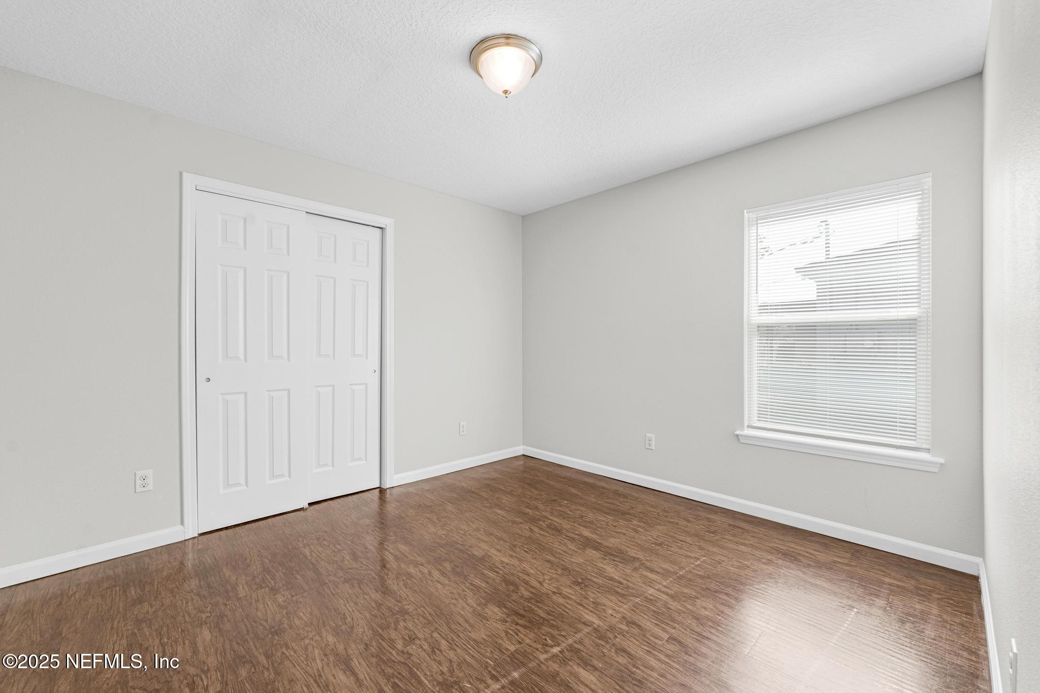 5120 Dugdale Road Jacksonville, FL 32210 - Photo 25 of 32 an empty room with windows and closet