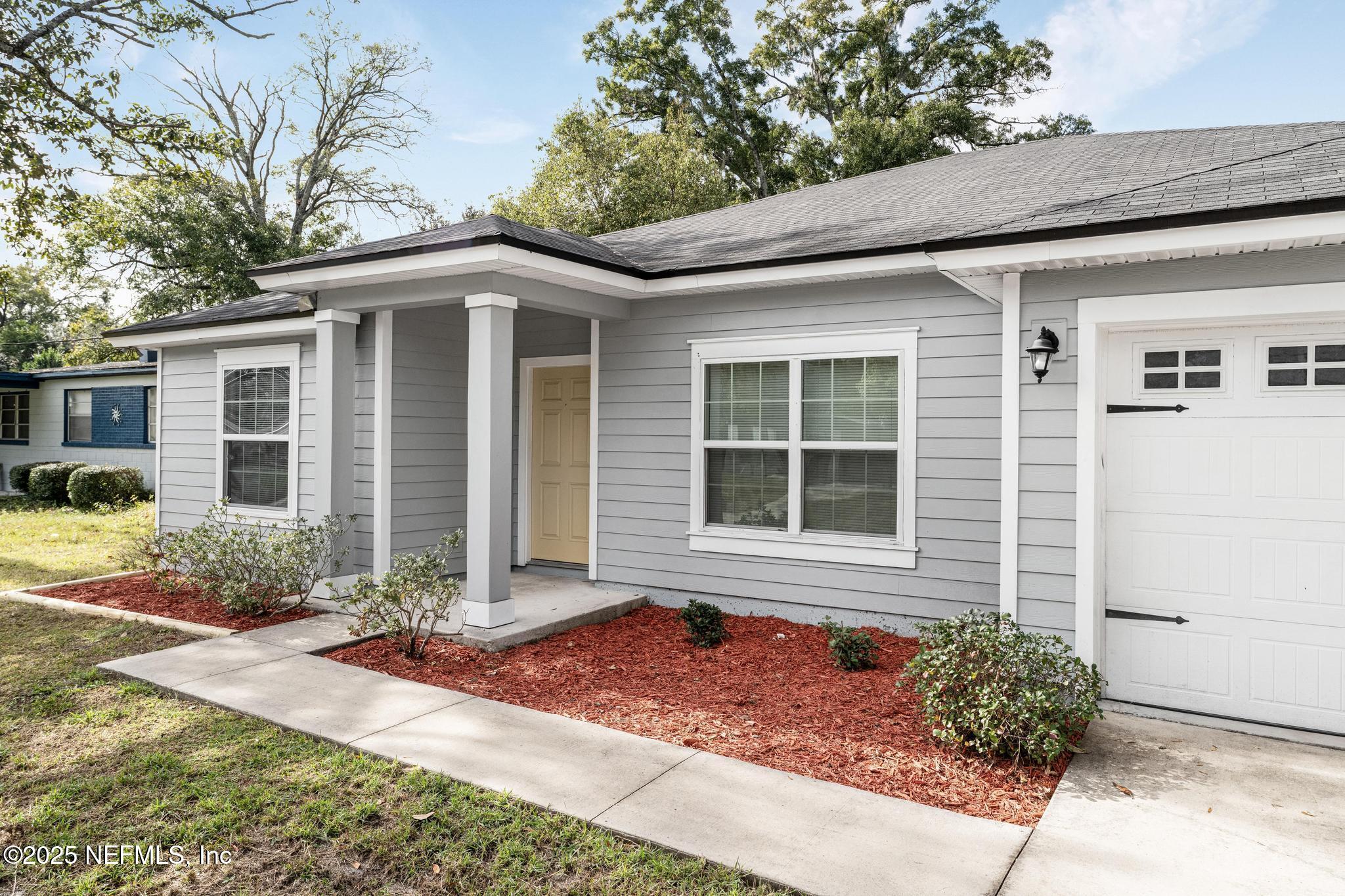 5120 Dugdale Road Jacksonville, FL 32210 - Photo 3 of 32 a front view of a house with garden