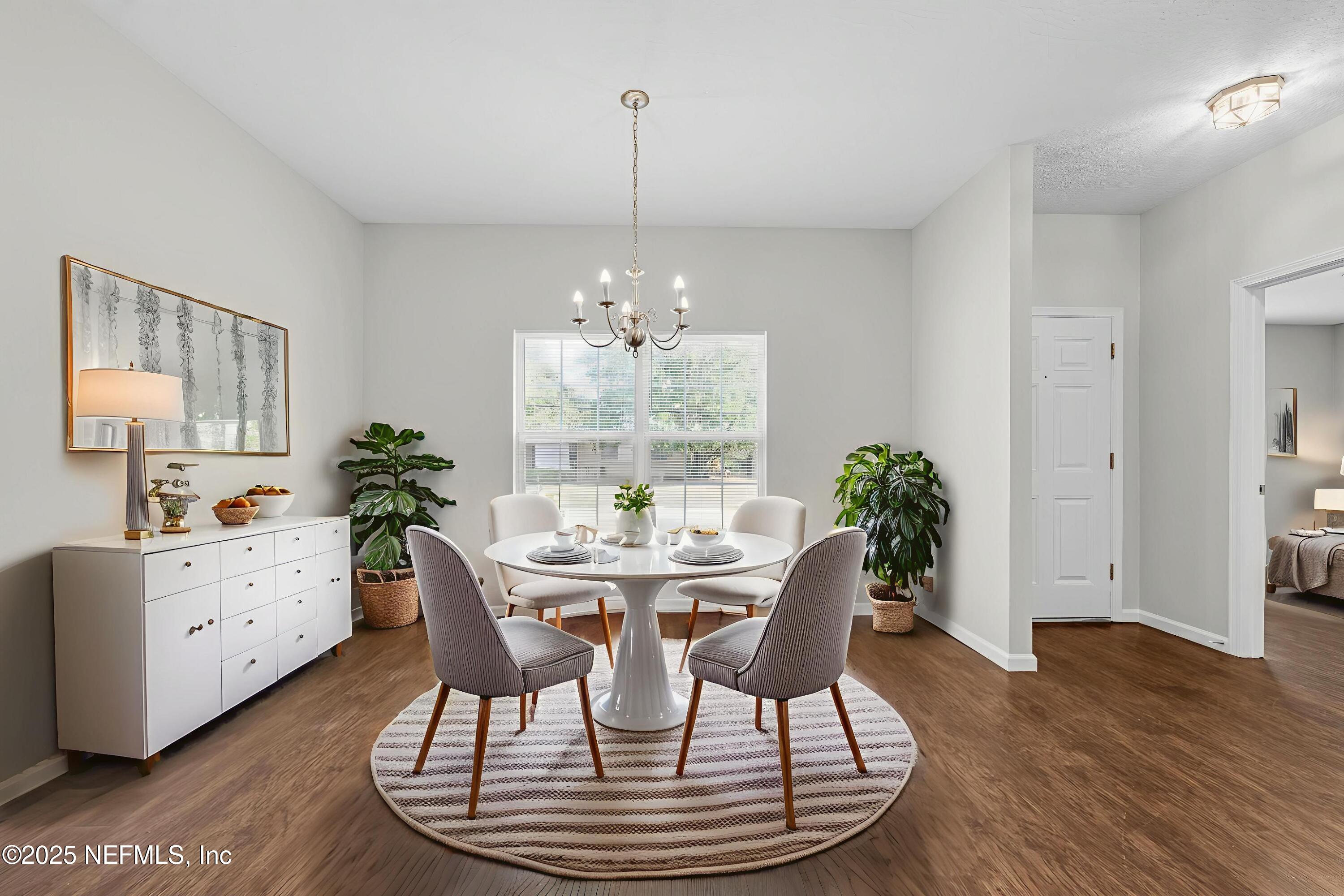 5120 Dugdale Road Jacksonville, FL 32210 - Photo 8 of 32 a view of a dining room with furniture window and wooden floor