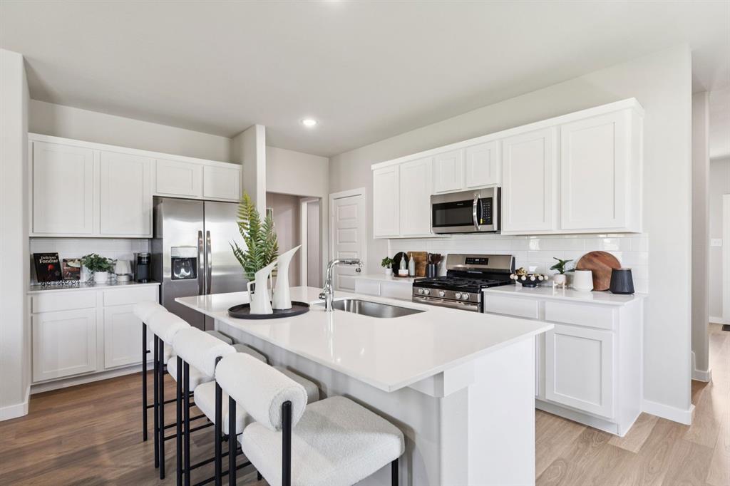 372 Millwood Road Lavon, TX 75166 - Photo 5 of 28 Kitchen in the Magnolia home plan by Trophy Signature Homes – REPRESENTATIVE PHOTO