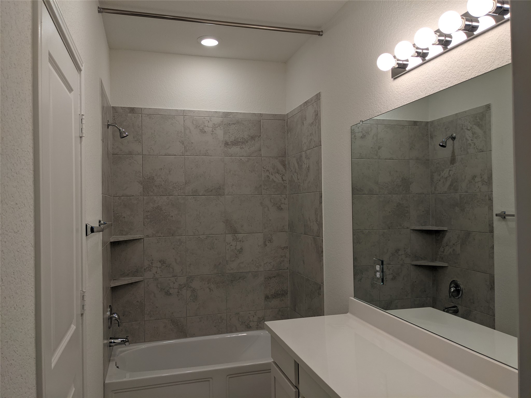 100 Montauk Loop Georgetown, TX 78628 - Photo 16 of 21 A well-appointed bathroom features a tub with shower, contemporary vanity, and generous mirror.